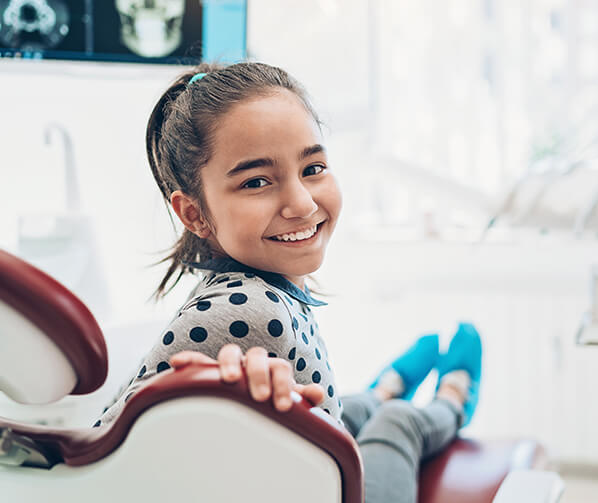 smiling girl sitting in a dental chair