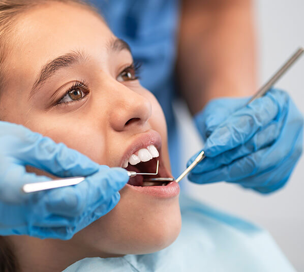 girl receiving a dental exam