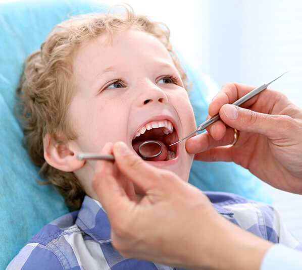 young boy receiving a dental exam