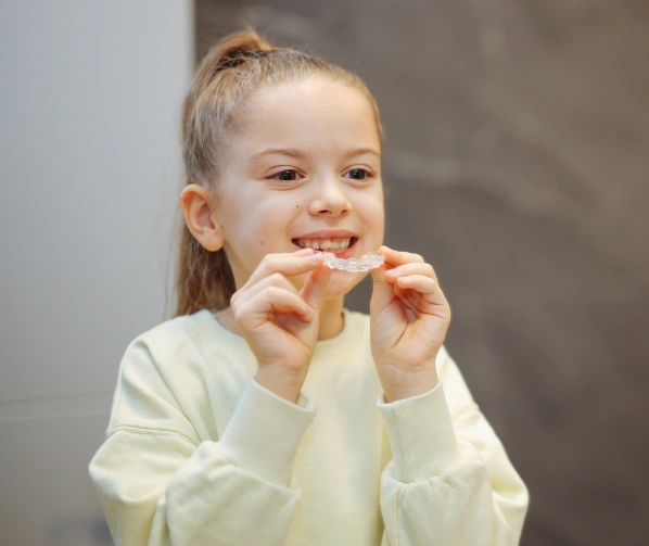 smiling girl sitting in a dental chair